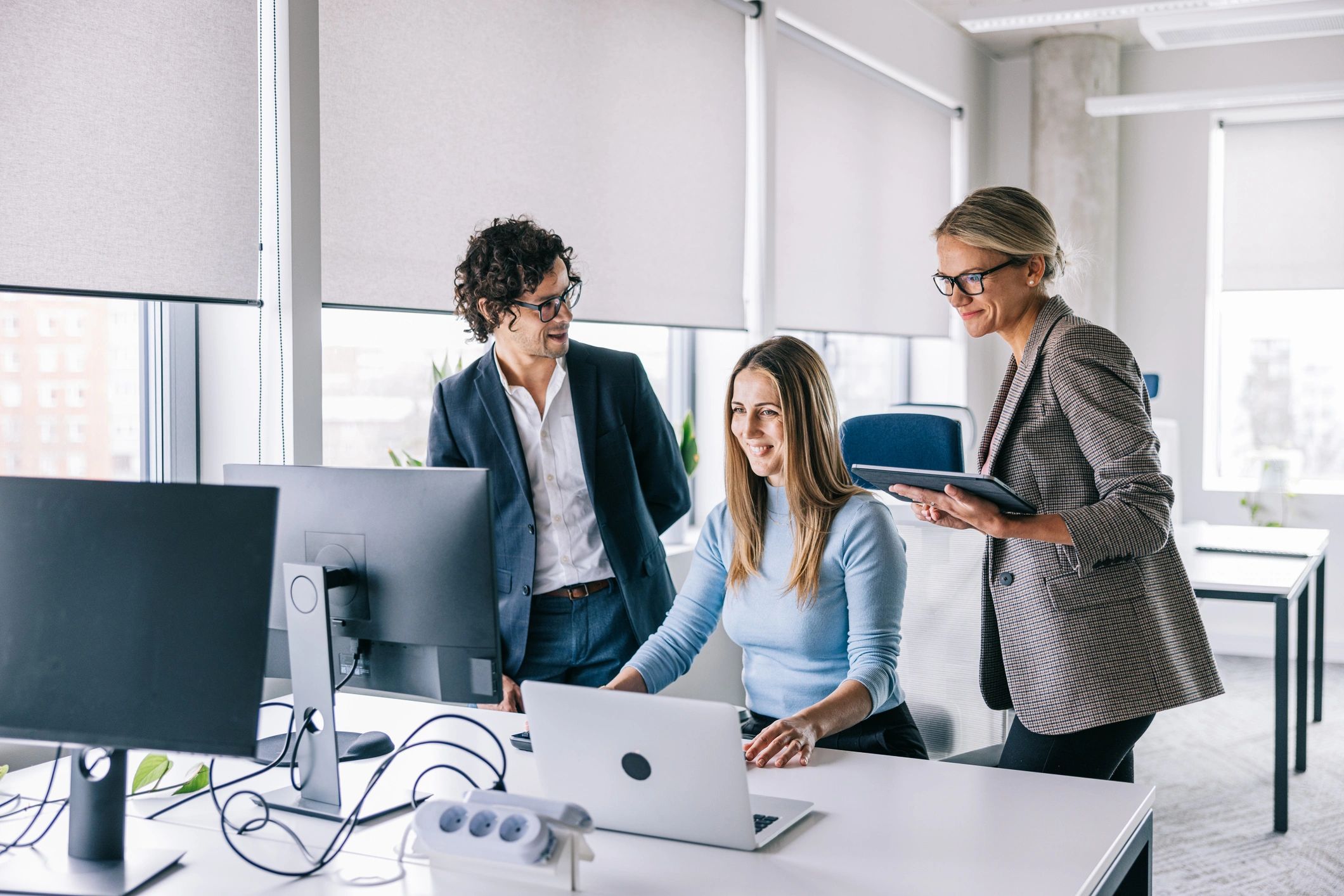 Technology consultants collaborating on a project in an office