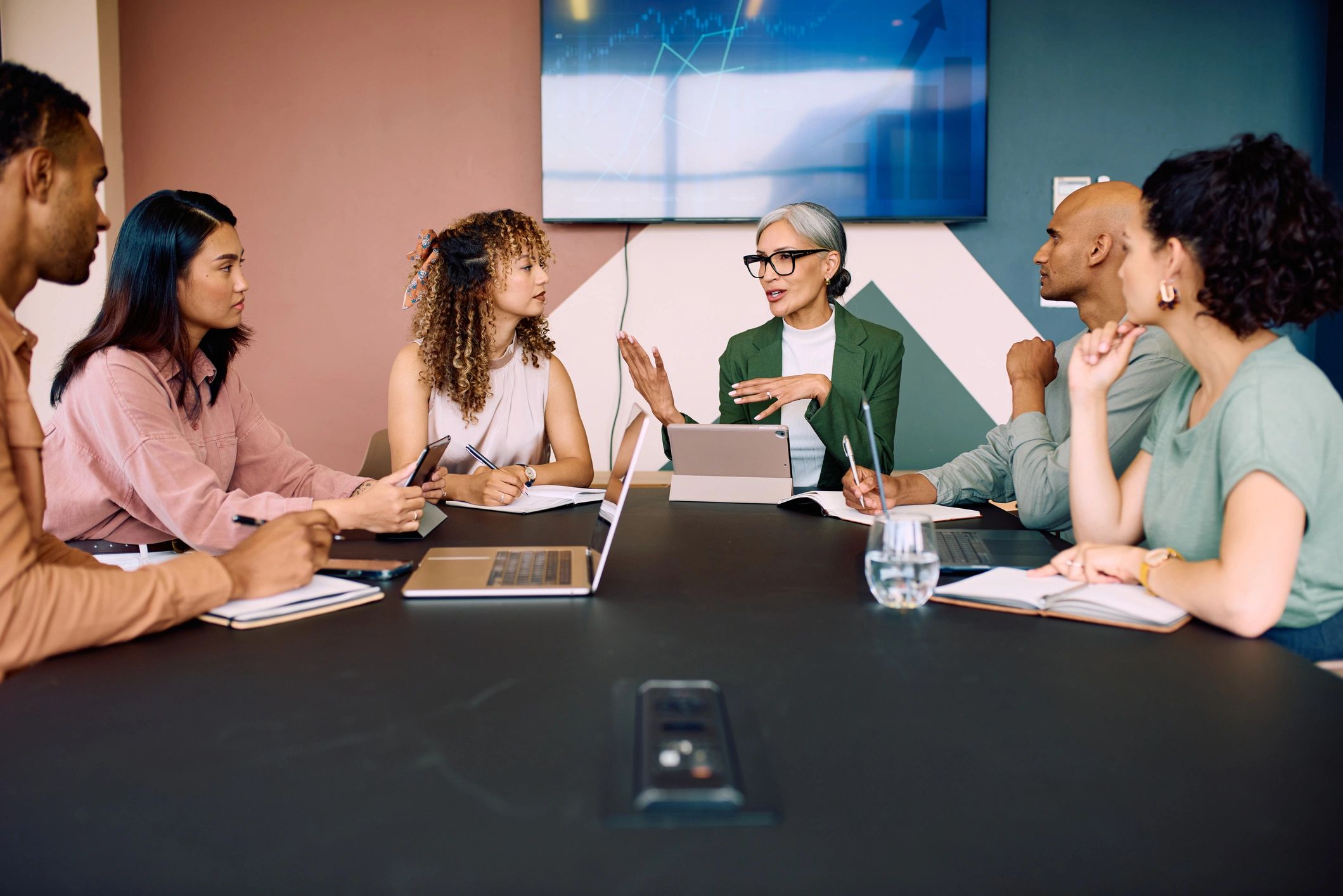 Colleagues discussing ideas around a boardroom table